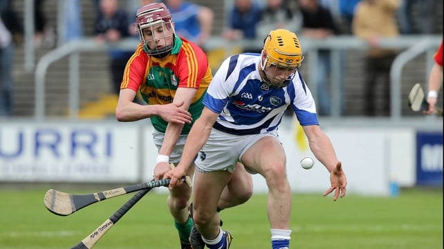 Laois' Brian Dunne vies for posession with with Alan Corcoran