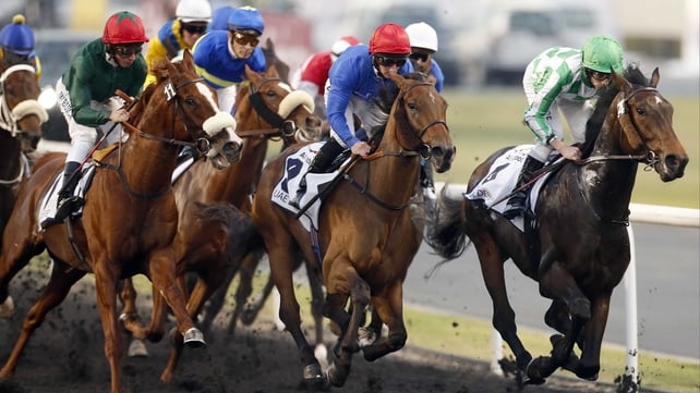 Lines Of Battle (right) leads the field on his way to victory in the UAE Derby