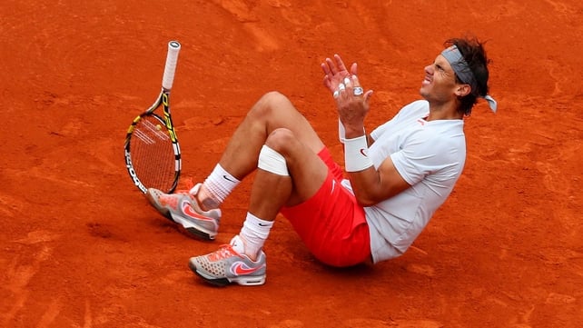 Rafael Nadal sinks on to the red clay of Court Philippe Chatrier after dispatching his backhand winner on match point