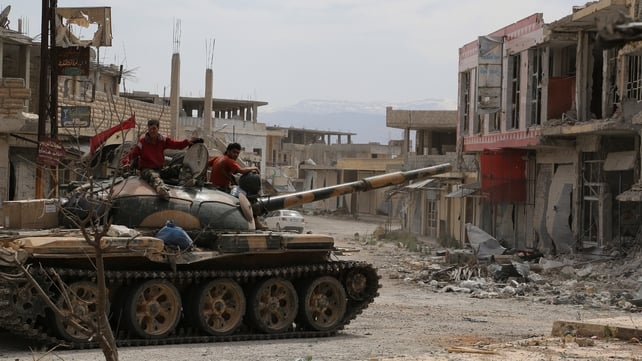 Syrian army soldiers drive a tank through the sacked town of Qusair Syrian army soldiers drive a tank through the sacked town of Qusair
