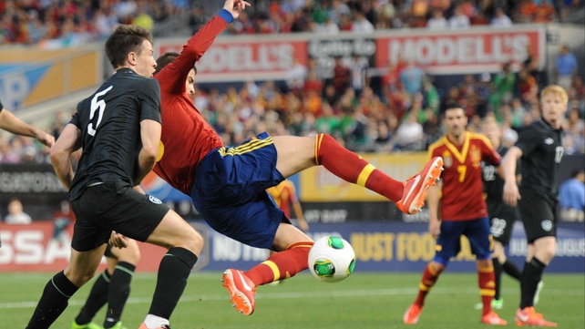 Sean St Ledger stays close to Gerard Pique