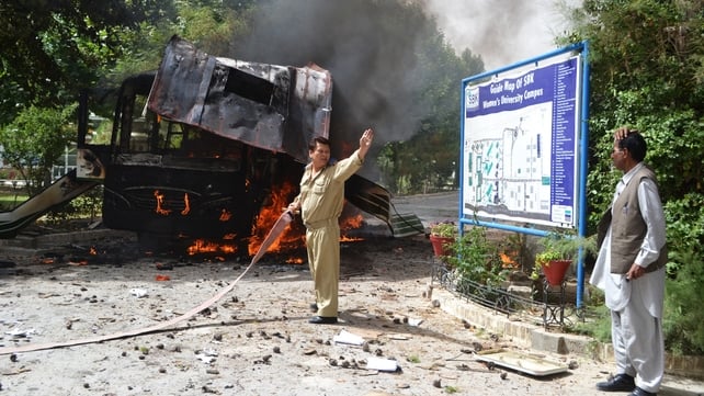 Firefighters extinguish flames in aftermath of explosion on a bus in Quetta, Pakistan Firefighters extinguish flames in aftermath of explosion on a bus in Quetta, Pakistan