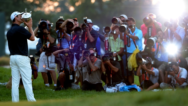 Justin Rose holds the US Open trophy aloft at Merion