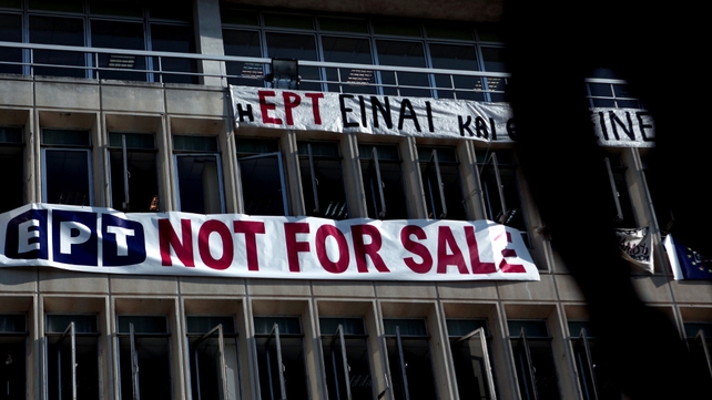 A 'not for sale' banner hangs on the facade of the Greek state television ERT headquarters A 'not for sale' banner hangs on the facade of the Greek state television ERT headquarters