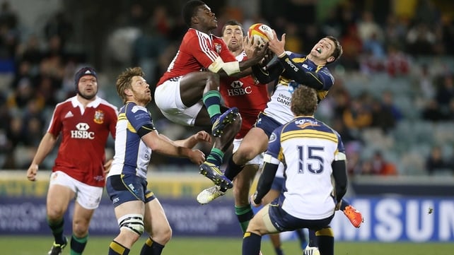 The Lions' Christian Wade and the Brumbies' Ian Prior vie for possession at Canberra Stadium