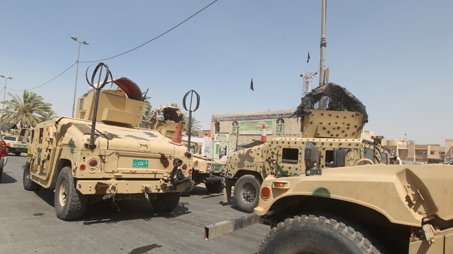Iraqi military vehicles are stationed in front of the Shia Muslim mosque in Baghdad Iraqi military vehicles are stationed in front of the Shia Muslim mosque in Baghdad
