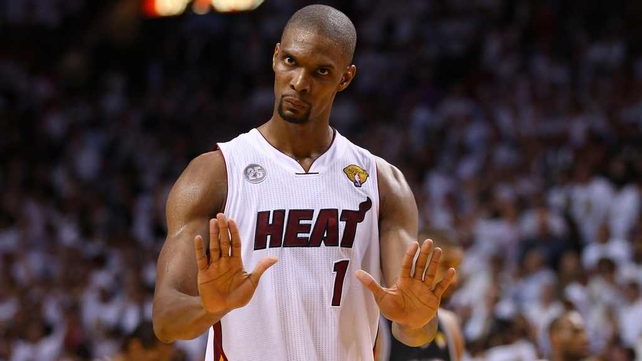 Miami Heat's Chris Bosh reacts in overtime against the San Antonio Spurs