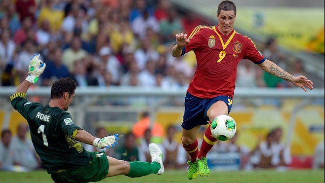 Fernando Torres rounds Tahiti goalkeeper Mickael Roche