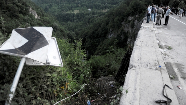 Onlookers at the scene where a bus crashed into a gorge in Montenegro yesterday, leaving 18 people dead Onlookers at the scene where a bus crashed into a gorge in Montenegro yesterday, leaving 18 people dead