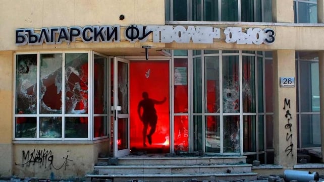A CSKA Sofia football club supporter runs into the Bulgarian Football Union building in Sofia