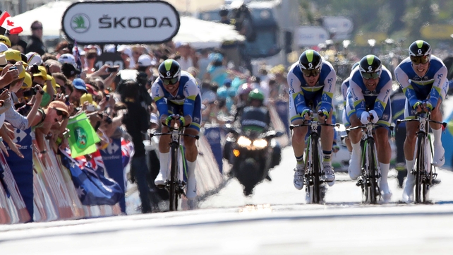 Riders of Orica GreenEdge team cross the finish line at the end of the 25 km team time-trial