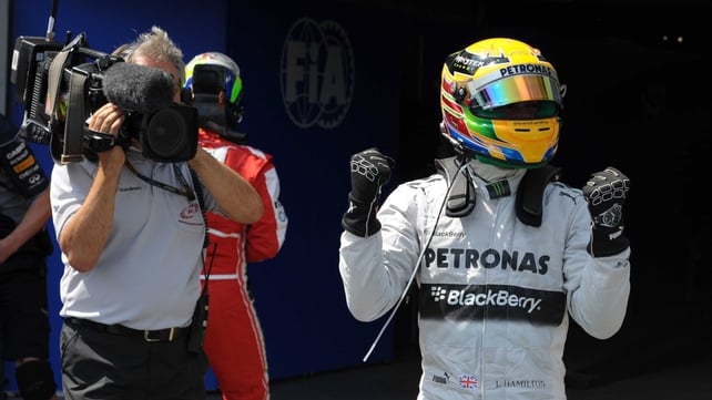 Lewis Hamilton shows his delight at earning pole position ahead of Sebastian Vettel