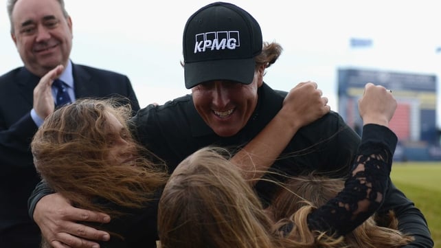 Phil Mickelson embraces his wife and daughter after winning at Castle Stuart