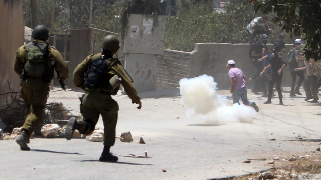Palestinian demonstrators run for cover during clashes with Israeli troops following a protest against the expropriation of Palestinian land by Israel in the village of Kfar Qaddum Palestinian demonstrators run for cover during clashes with Israeli troops following a protest against the expropriation of Palestinian land by Israel in the village of Kfar Qaddum