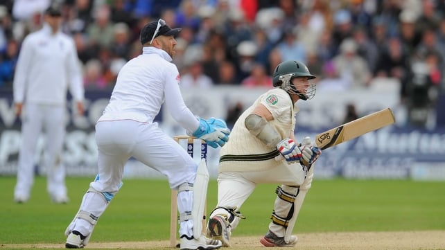 Chris Rogers reaches his century with a sweep for four watched by Matt Prior