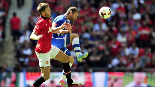 Manchester United's English midfielder Michael Carrick (L) vies with Wigan Athletic's Malaysian-born Scottish midfielder Shaun Maloney 