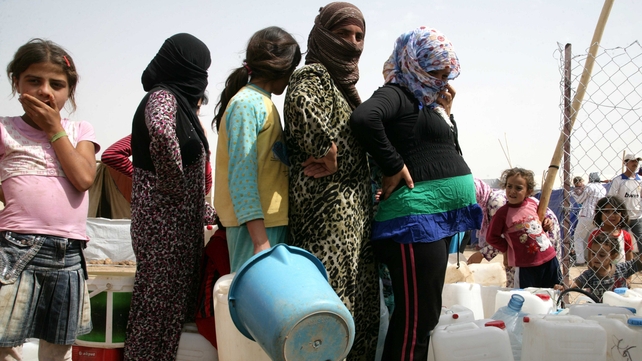 Syrian refugees queue for water at the Domiz refugee camp in northern Iraq Syrian refugees queue for water at the Domiz refugee camp in northern Iraq