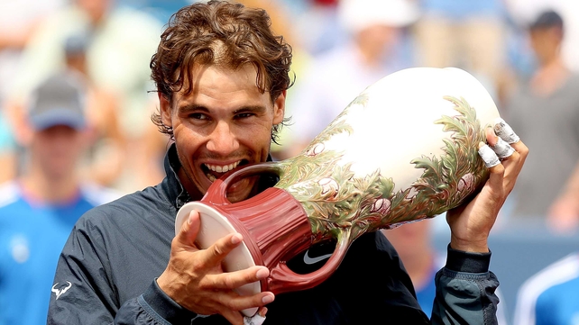 Rafael Nadal adopts his customary trophy ceremony pose with the Rookwood Cup