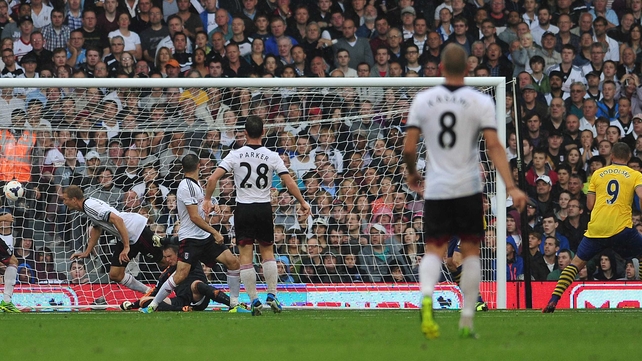 Arsenal's German striker Lukas Podolski (r) scores their second goal