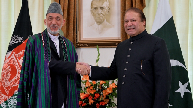 Afghan President Hamid Karzai and Pakistani Prime Minister Nawaz Sharif shake hands for photographers in Islamabad Afghan President Hamid Karzai and Pakistani Prime Minister Nawaz Sharif shake hands for photographers in Islamabad