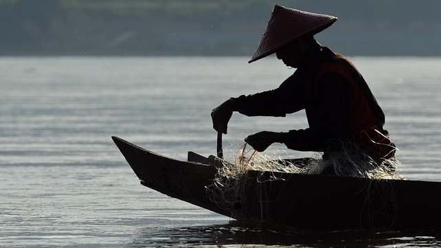 A fisherman on the Mekong river, proposed site of 11 hydroelectric dams A fisherman on the Mekong river, proposed site of 11 hydroelectric dams