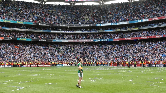 A dejected Darran O'Sullivan stands alone as Dublin lift Sam Maguire in 2011