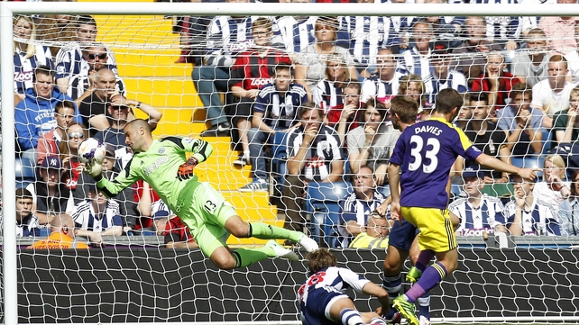 Swansea City's Ben Davies (R) scores past West Brom goalkeeper Boaz Myhill