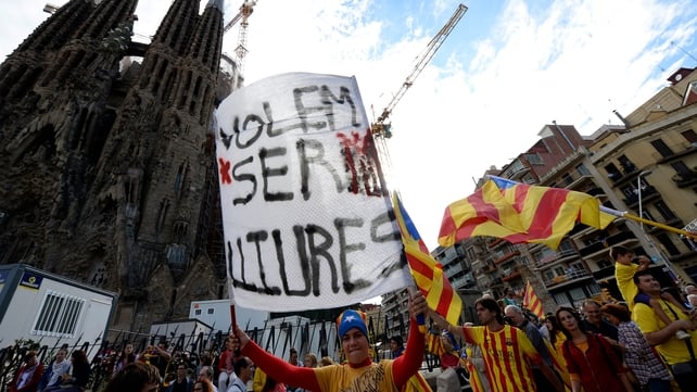 A Catalan holds a banner reading 'We want to be free' as he and thousands of Catalans gather to create a 400km human chain in front of the Sagrada Familia basilica in Barcelona A Catalan holds a banner reading 'We want to be free' as he and thousands of Catalans gather to create a 400km human chain in front of the Sagrada Familia basilica in Barcelona