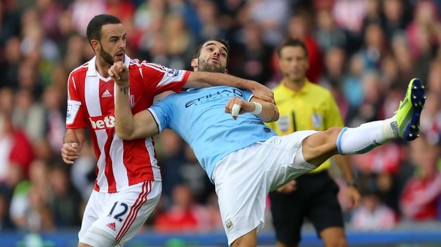 Stoke City's Marc Wilson (l) tussles with Alvaro Negredo