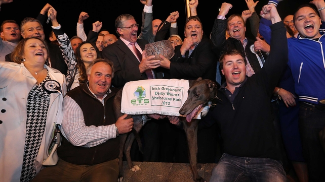 Slippery Robert with trainer Robert Gleeson (r) after winning the Irish Greyhound Derby at Shelbourne Park