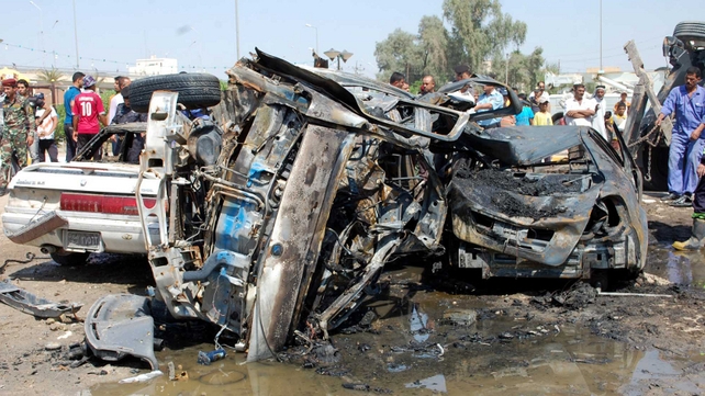 Iraqis gathering near burnt vehicles at the scene of a car bomb explosion in Nasiriyah, south of the Iraqi capital Baghdad Iraqis gathering near burnt vehicles at the scene of a car bomb explosion in Nasiriyah, south of the Iraqi capital Baghdad