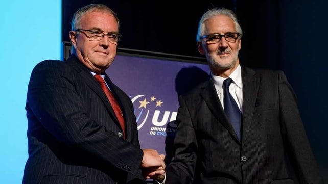 Pat McQuaid shakes hands with Brian Cooks as the election for the next president of the international cycling union looms