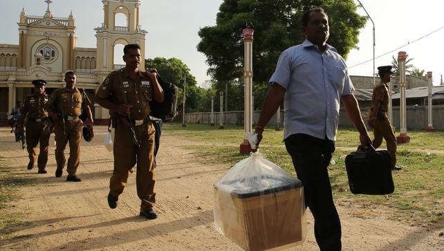 A Sri Lankan poll officer carries a sealed ballot box at a counting centre in Jaffna A Sri Lankan poll officer carries a sealed ballot box at a counting centre in Jaffna