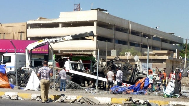 A destroyed vehicle is removed following a car bomb in a car park in Baghdad A destroyed vehicle is removed following a car bomb in a car park in Baghdad