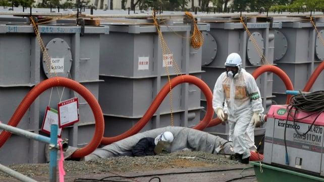 Workers examining waste water tanks at the Fukushima plant in June Workers examining waste water tanks at the Fukushima plant in June