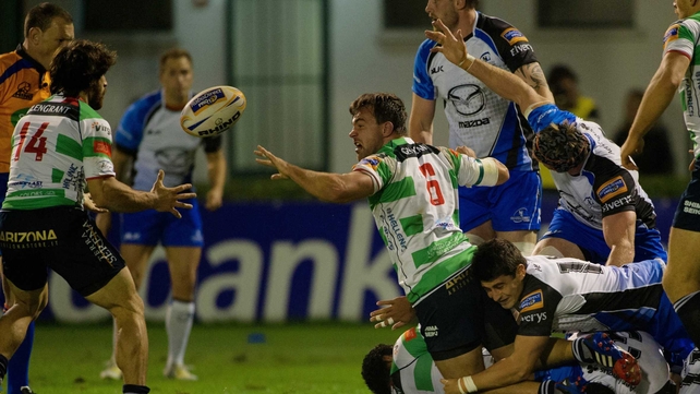 Treviso's Simone Favaro offloads as Fionn Carr tackles