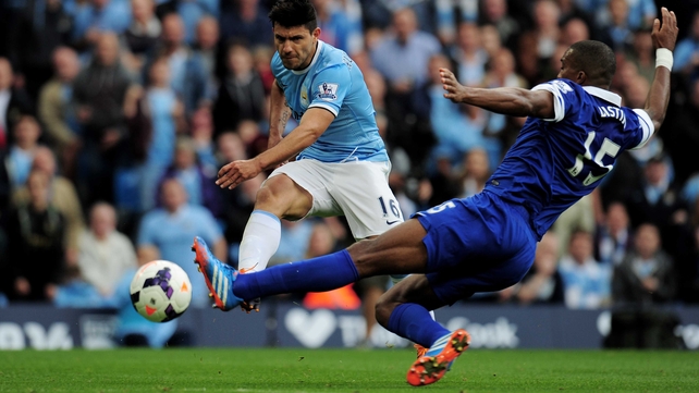 Sergio Aguero of Manchester City shoots past Sylvain Distin of Everton to score his team's second goal