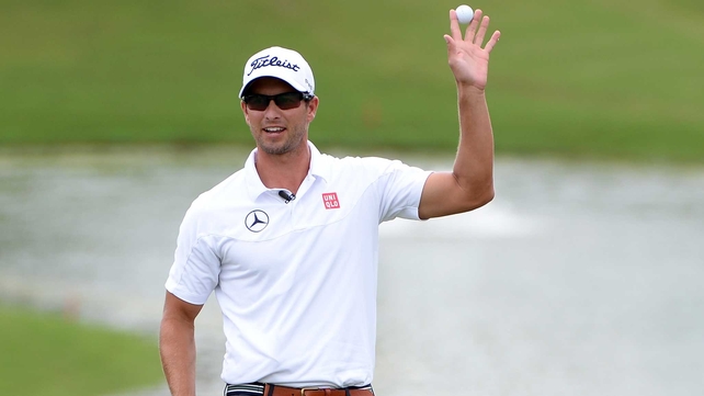 Scott celebrates after making the winning putt