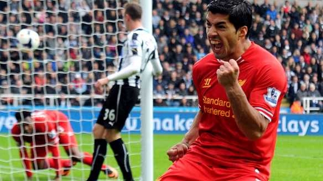 Luis Suarez celebrates after setting up a goal for Daniel Sturridge