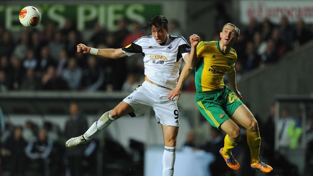 Swansea's Michu and Aleksei Kozlov of Kuban Krasnodar compete for the ball in tonight's Europa League clash