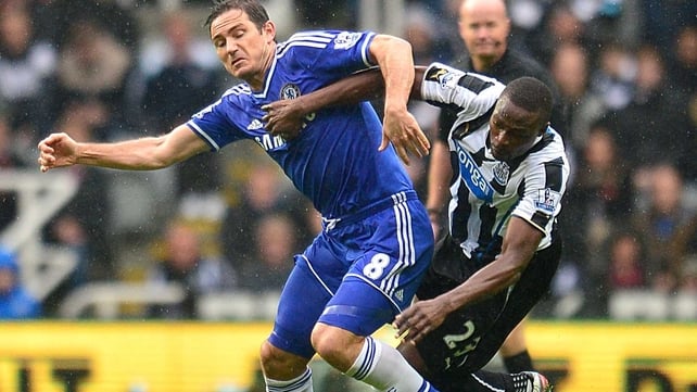 Chelsea's Frank Lampard (left) and Newcastle United's Shola Ameobi battle for possession