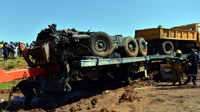 Emergency services clear the scene after a truck collided with a bus filled with commuters, killing 29 people Emergency services clear the scene after a truck collided with a bus filled with commuters, killing 29 people