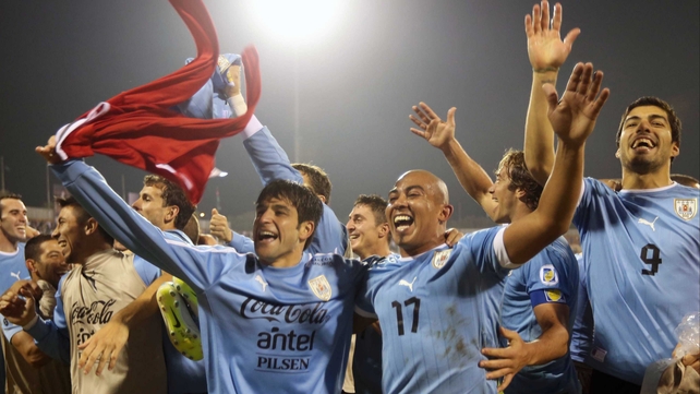 Uruguay players celebrate after the all but cement their place in the World Cup