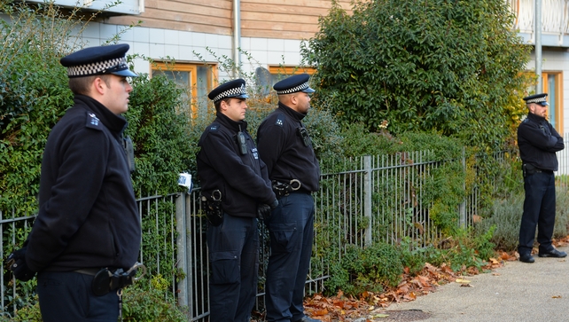 Police stand guard outside a block of flats in south London Police stand guard outside a block of flats in south London