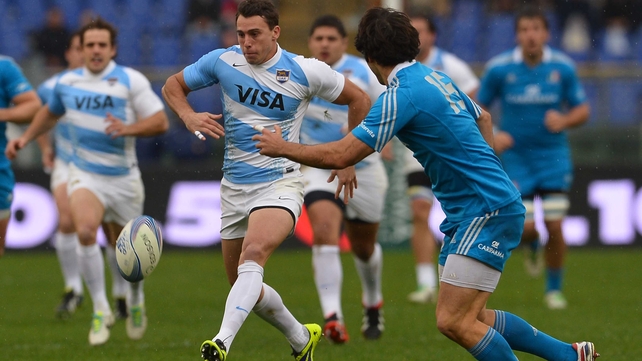 Argentinian winger Juan Imhoff (c) kicks the ball as Italy's fullback Luke McLean looks on