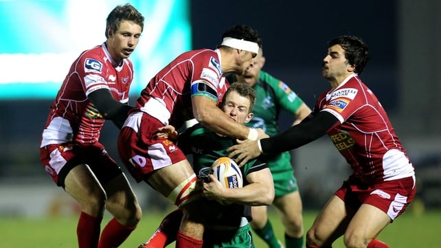 Connacht's Matt Healy is tackled by Sione Timani and Gareth Owen of Scarlets