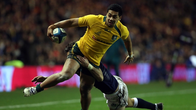 Scotland's Sean Maitland tries but fails to stop Chris Feauai-Sautia from touching down for Australia