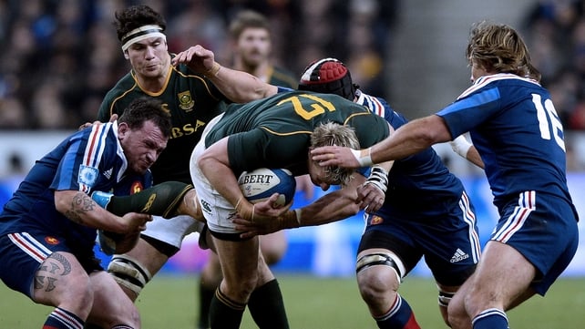 South Africa captain Jean de Villiers is tackled by Nicolas Mas (left) and Dimitri Szarzewski (right) of France