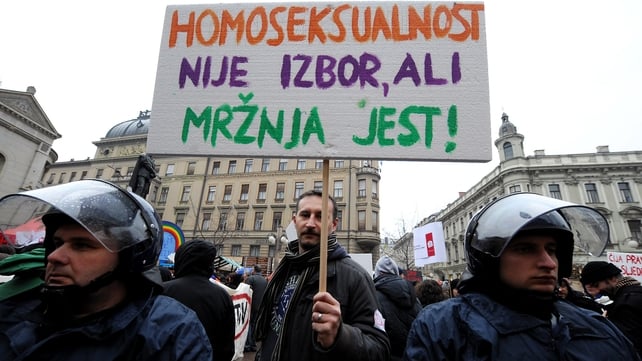 A protester holds a sign reading 'Homosexuality is not a choice, hate is a choice' next to riot policemen as Croatian gay rights activists protest in Zagreb A protester holds a sign reading 'Homosexuality is not a choice, hate is a choice' next to riot policemen as Croatian gay rights activists protest in Zagreb
