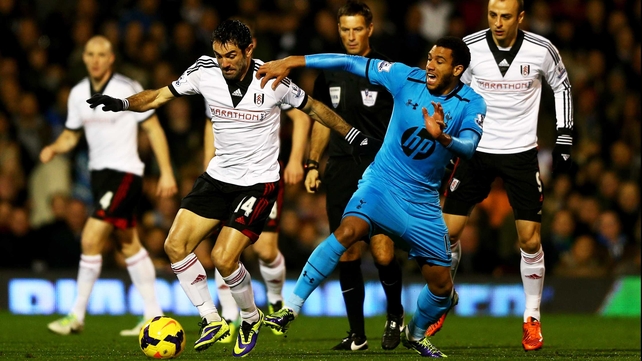 Giorgos Karagounis of Fulham holds off Etienne Capoue of Tottenham